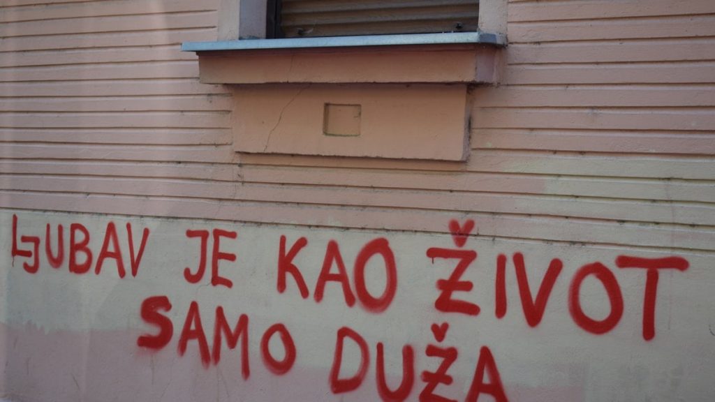 Red graffiti on a building wall