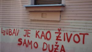 Red graffiti on a building wall